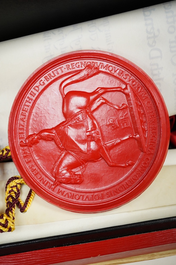 The Hon. Lord Justice Slade, ‘A Writ of Attendance at Parliament’, two vellum documents with ERII red seals in a red fitted case with a gold Royal Coat of Arms stamp, case 59cm wide x 23cm deep. Condition - some foxing